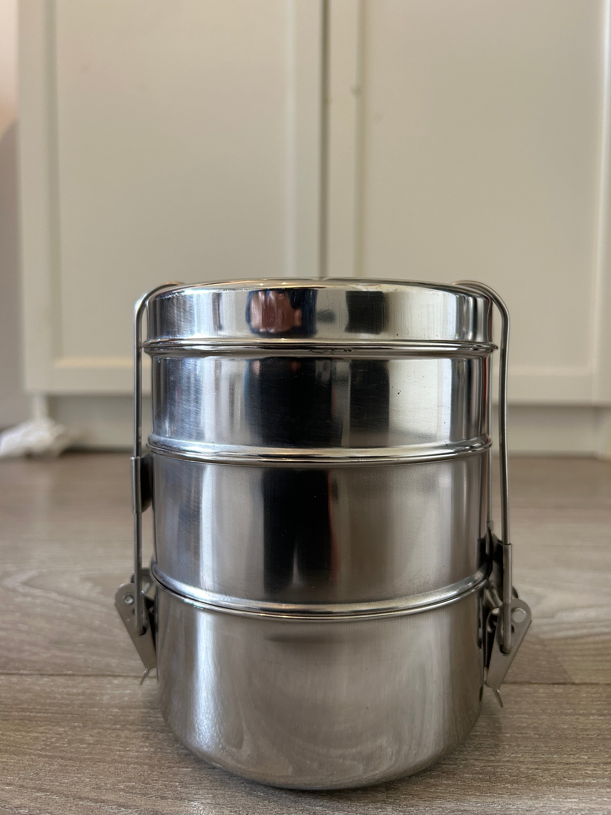 Metallic container on a wooden surface